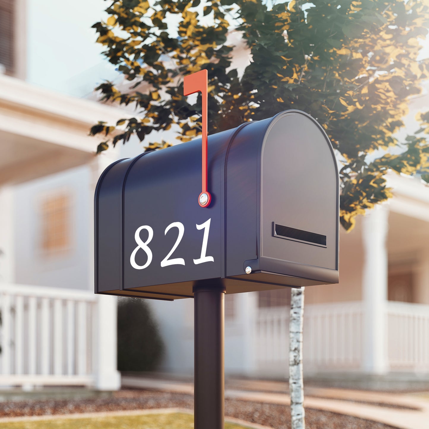 Reflective mailbox number stickers displayed on a black mailbox in front of a modern home, offering clear visibility for your letterbox numbers day and night.