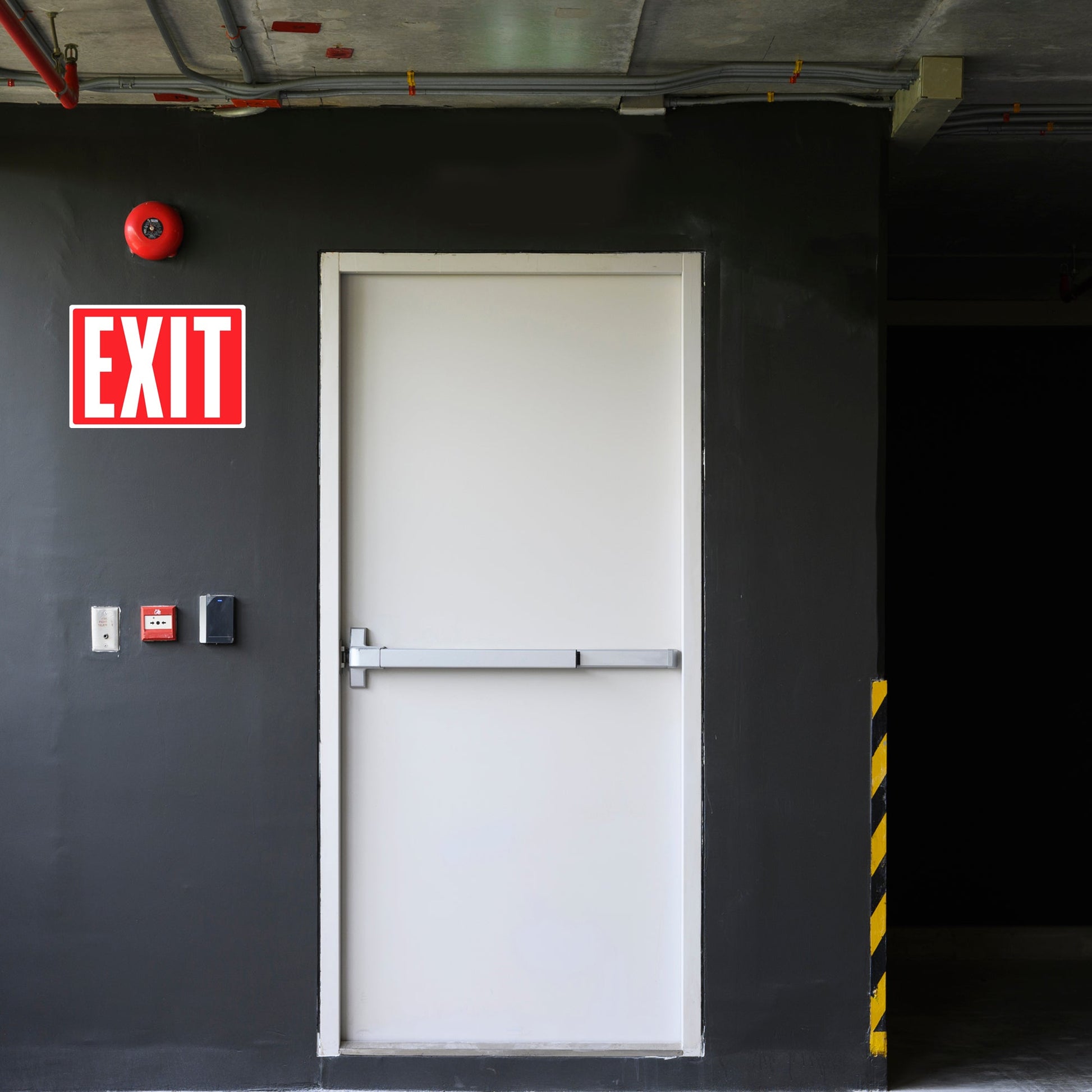 Photoluminescent exit sign sticker installed on a warehouse door. This exit door signage provides clear markings for safe evacuation during emergencies, especially in low-light situations.