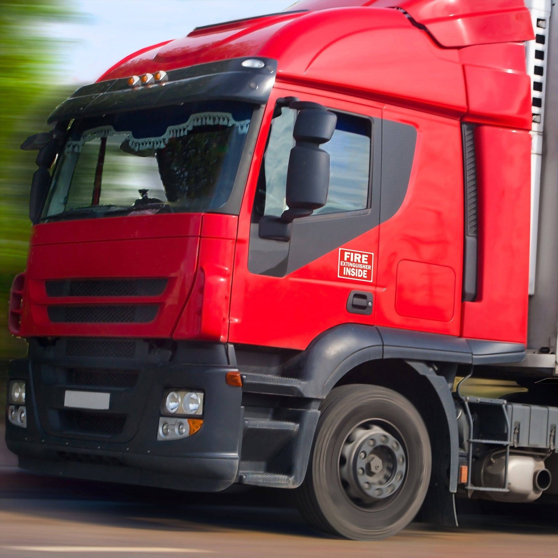 Red truck displaying a fire extinguisher inside sticker for improved safety and visibility during emergencies