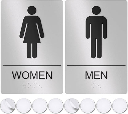 Silver restroom signs for men and women with black pictograms, ideal for commercial or public bathrooms