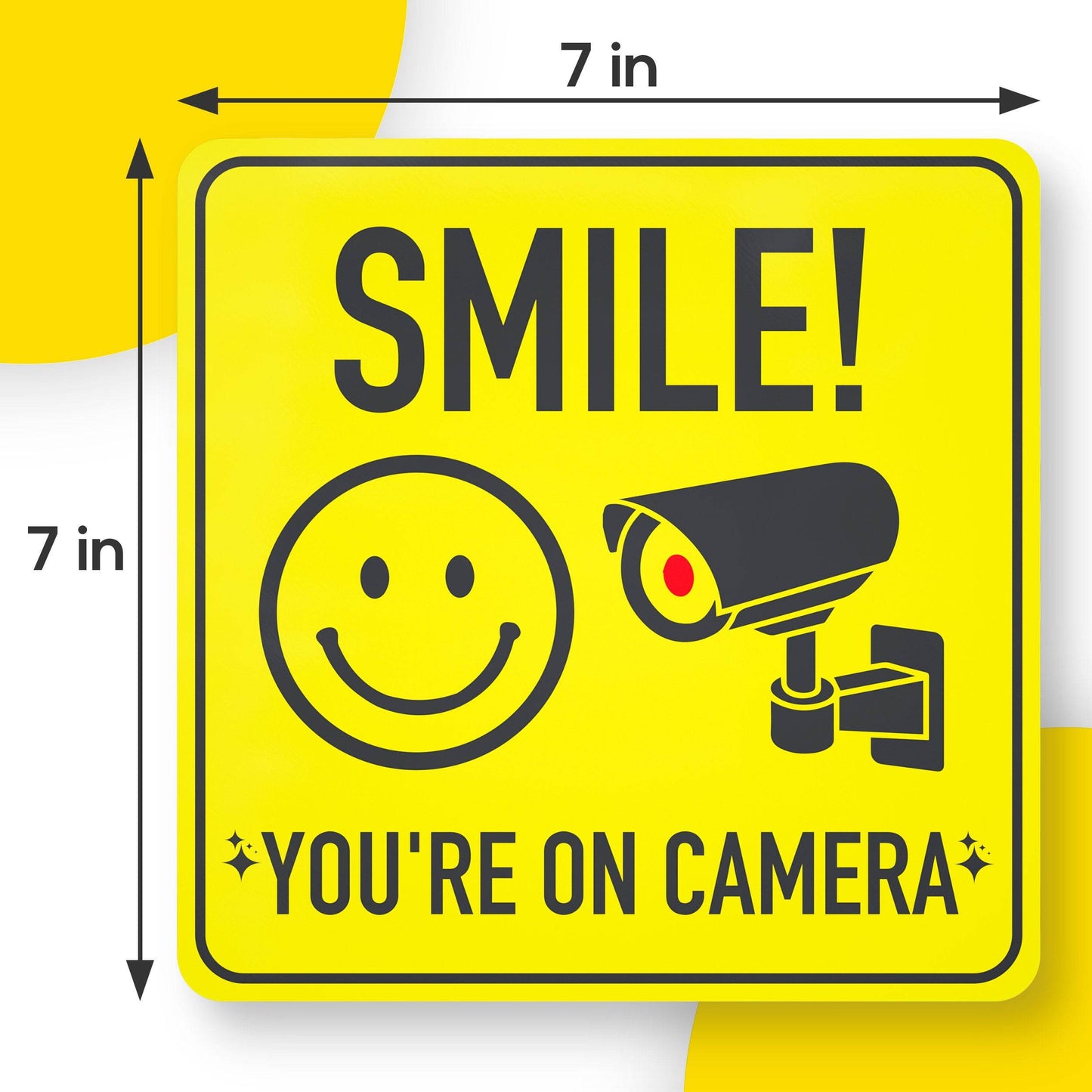 Smile You're On Camera Sign Sticker 7x7 inches with highly visible yellow and black design, perfect for all smooth surfaces such as glass and walls