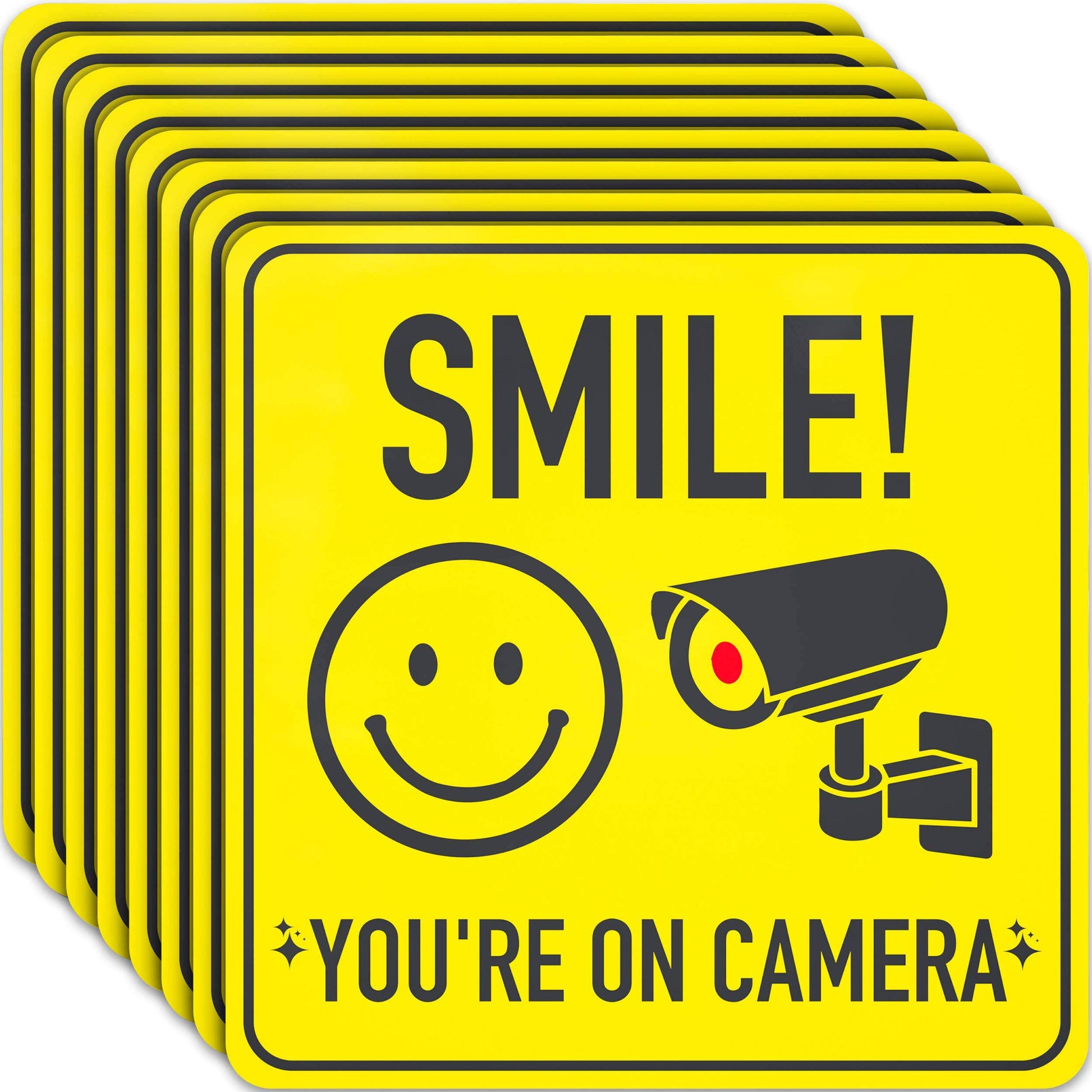 Smile You're On Camera Sign Stickers - 8 Pack featuring bright yellow signs with a smiley face and CCTV camera image, perfect for discouraging theft and improving security